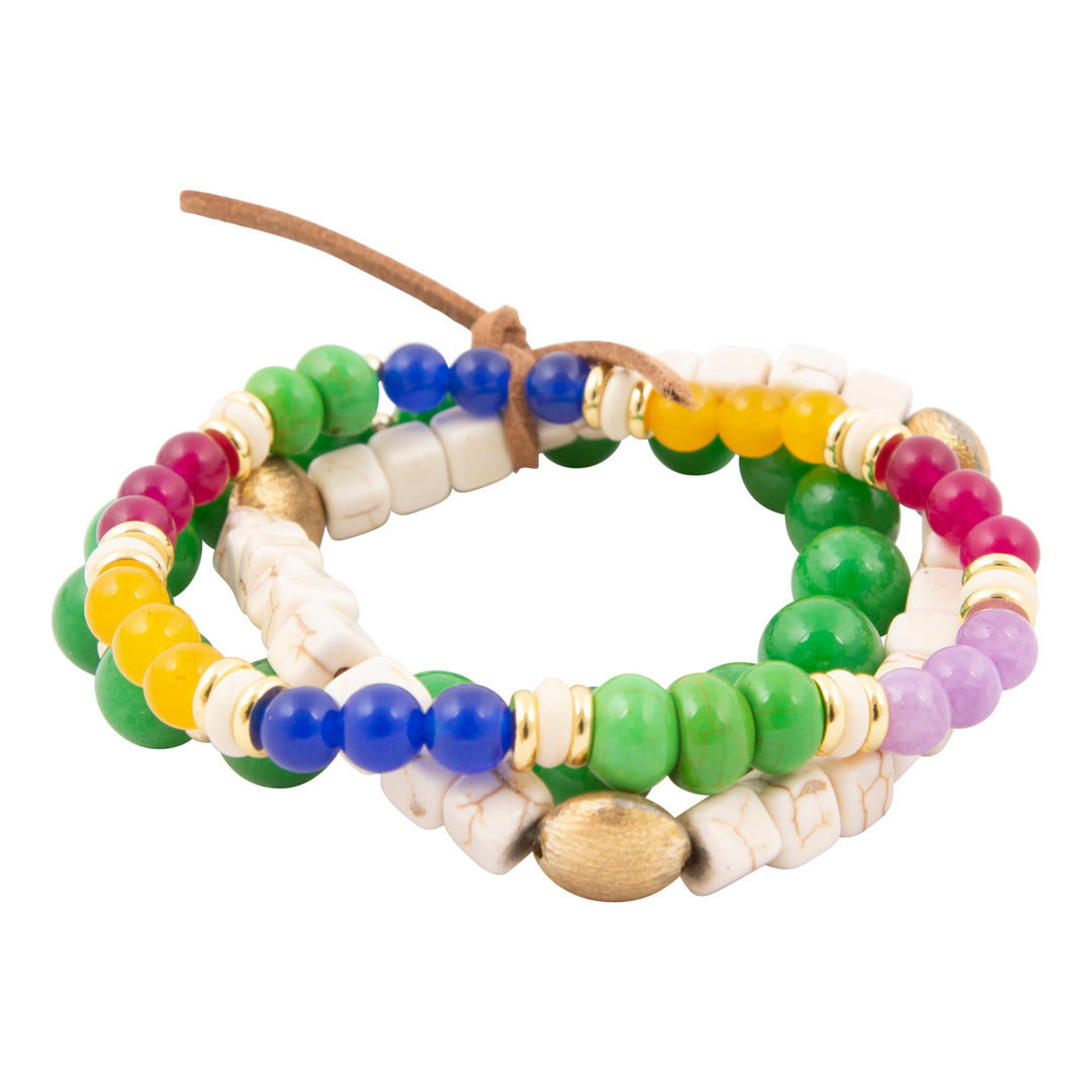 Stack of colorful beaded bracelets on a white background