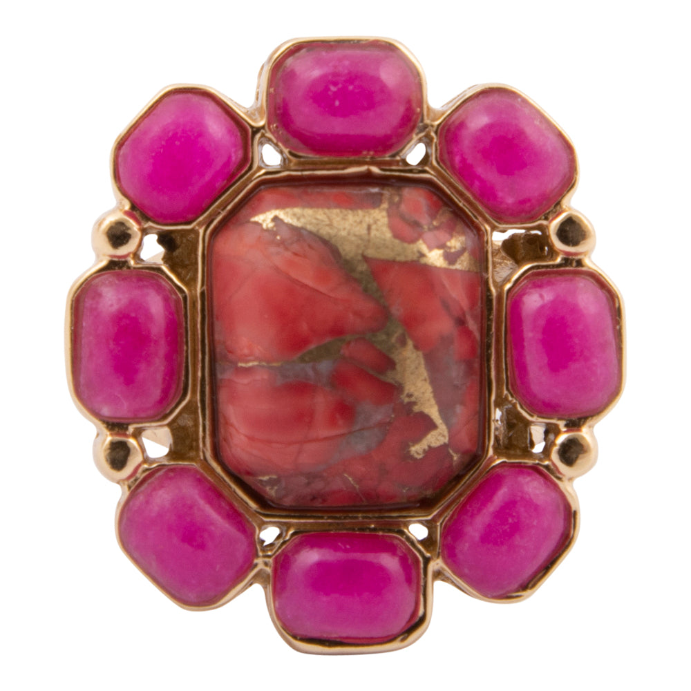 Gold ring with pink gemstones on a white background