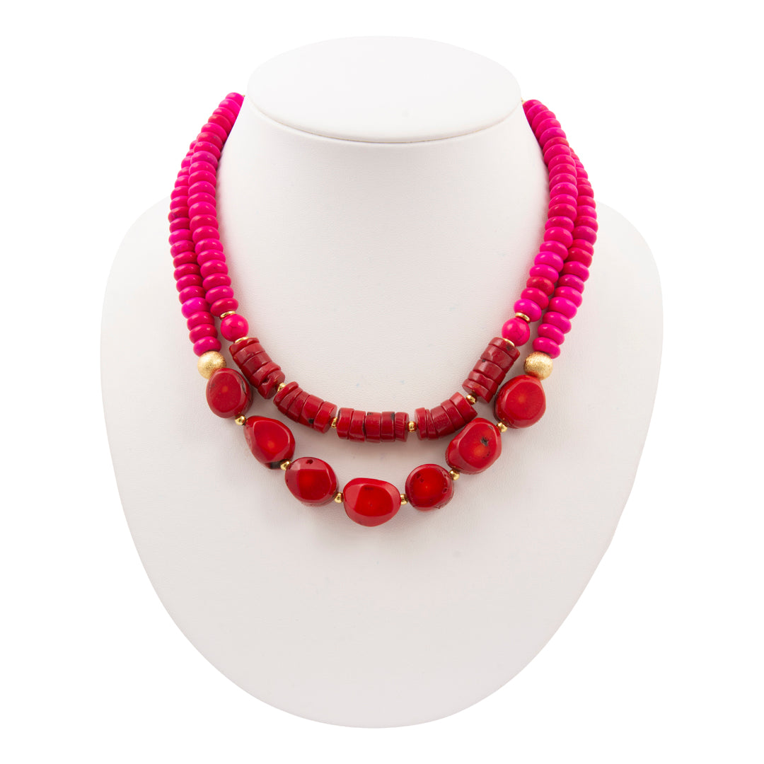 Necklace with pink and red beads on a white background