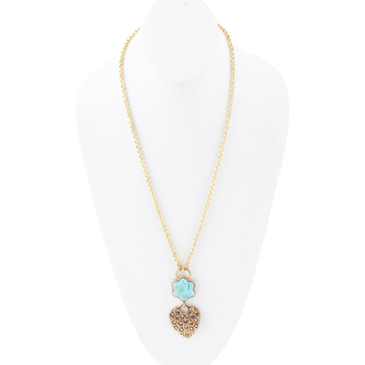 A gold chain necklace displayed on a white mannequin bust, featuring a double-drop pendant with a light blue flower charm and a textured gold heart.