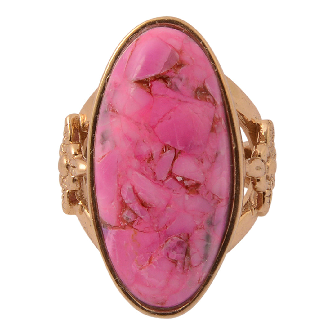 Ring with a pink stone and gold setting on a white background