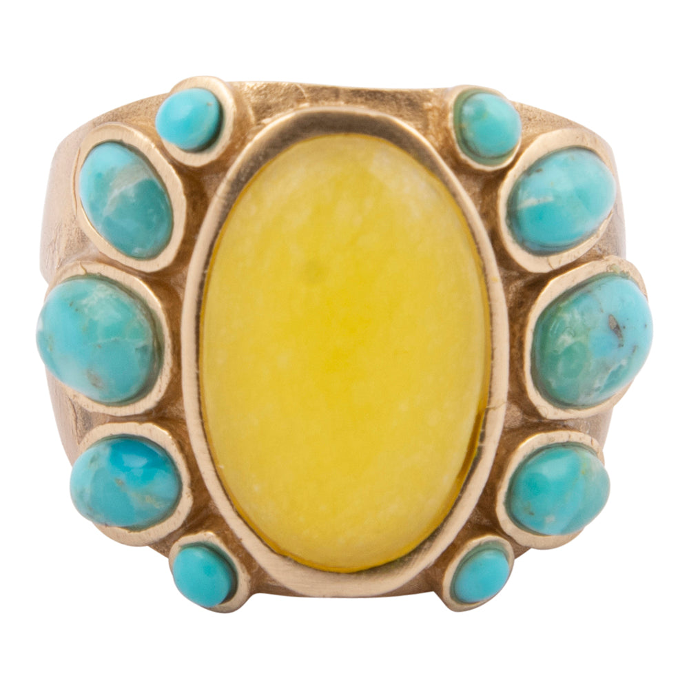 Ring with yellow stone and turquoise stones on a white background
