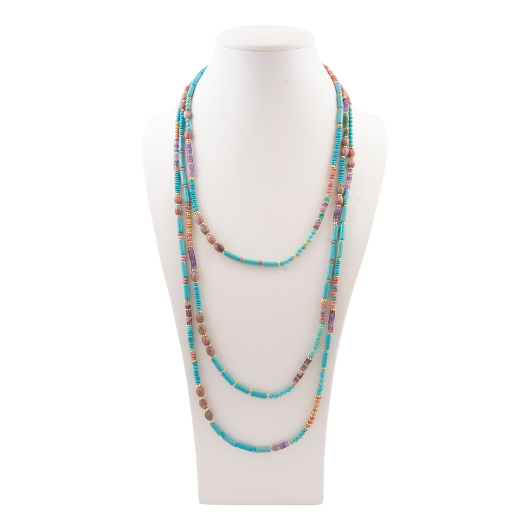 Multicolored beaded necklace on a mannequin bust against a white background