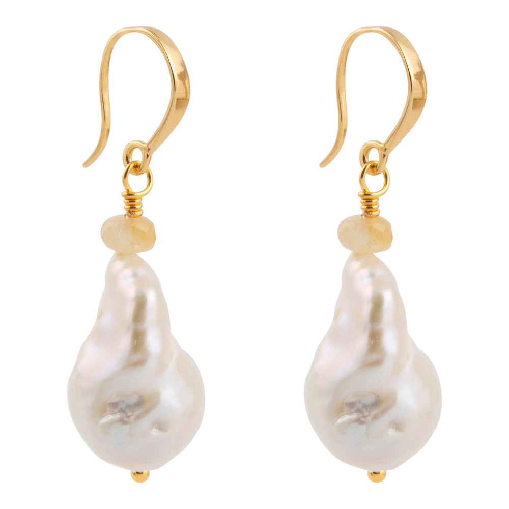 A pair of gold drop earrings featuring irregular, baroque-shaped white freshwater pearls and a small round gold bead below the hooks, set against a plain white background.