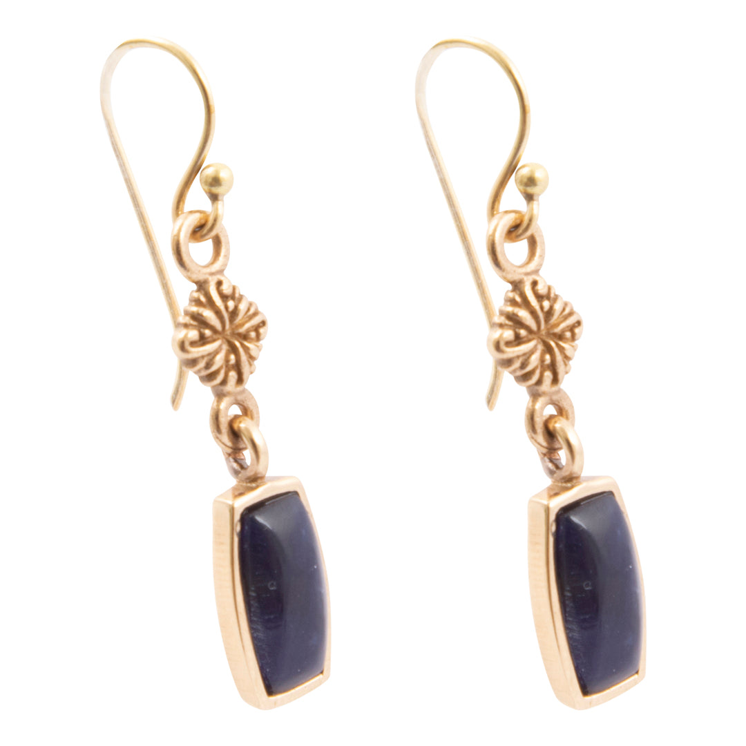 Gold earrings with blue stones on a white background