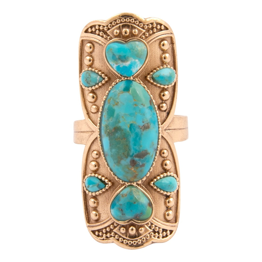 Gold ring with turquoise stones on a white background