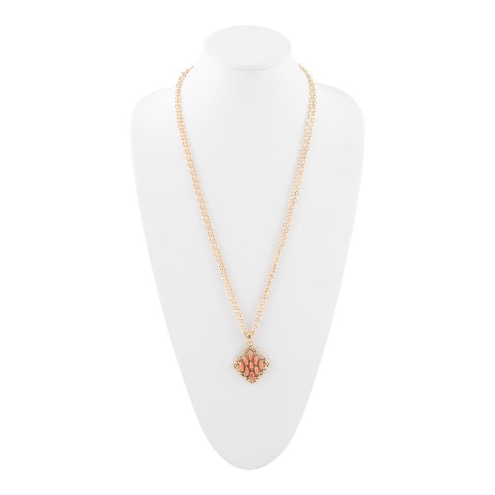 Gold necklace with a floral pendant on a white mannequin bust