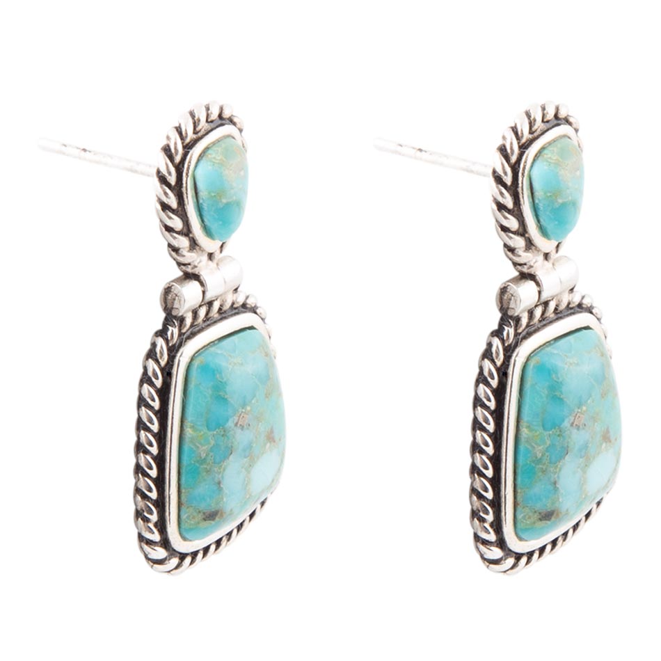 Turquoise stone earrings with silver frames on a white background