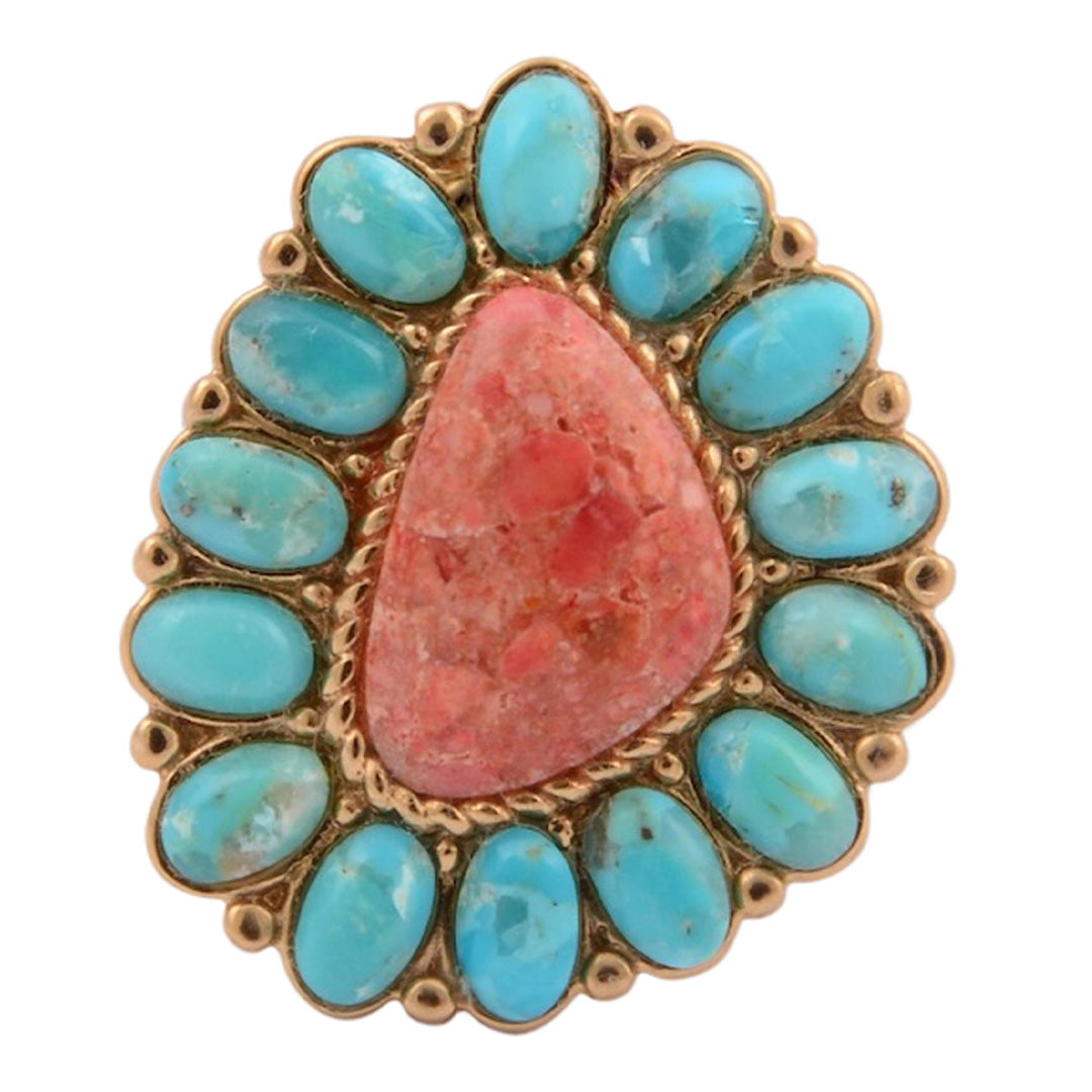 Ring with turquoise stones and a pink central stone on a white background
