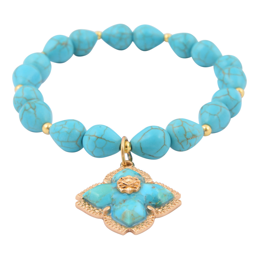 Turquoise beaded bracelet with a gold charm on a white background