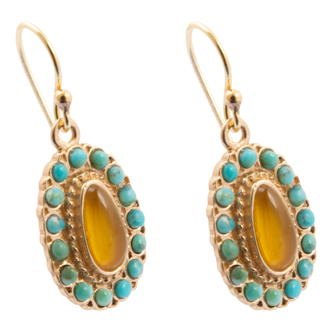 Gold earrings with turquoise stones and a yellow center stone on a white background