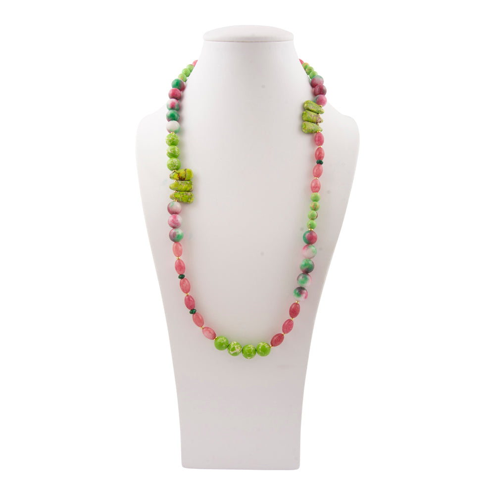 Necklace with green and pink beads on a white mannequin bust against a white background