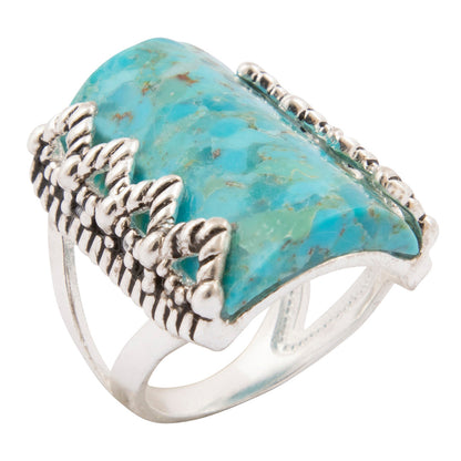 Turquoise stone ring with silver band on a white background