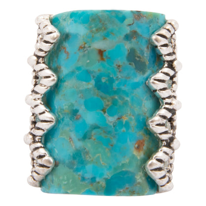 Turquoise stone ring with silver band on a white background