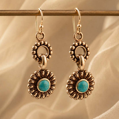 Agave turquoise bronze earrings against a warm lifestyle background