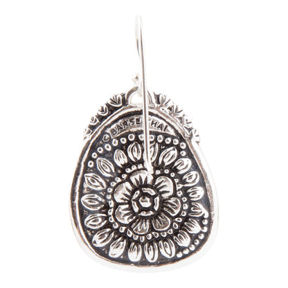 Silver mandala design earring on a white background
