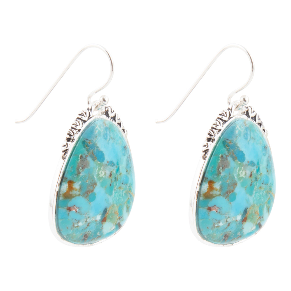 Turquoise teardrop earrings with silver settings on a white background