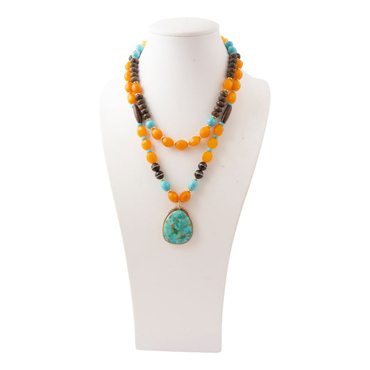 Barse Earthbound layered turquoise pendant necklace with magnesite, yellow jasper, bronzite and wood on a white bust