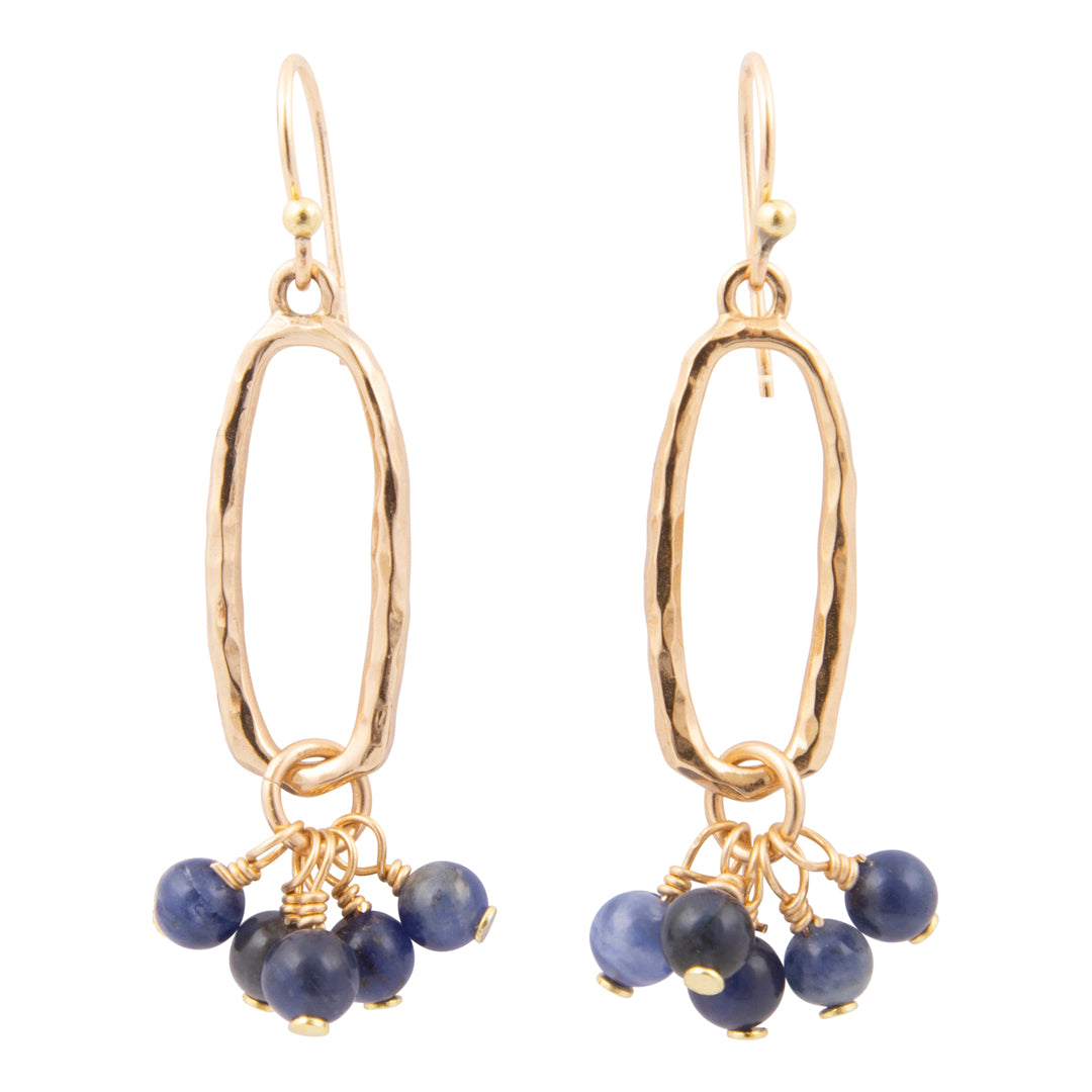 Gold earrings with blue beads on a white background