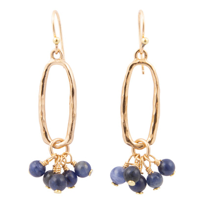 Gold earrings with blue beads on a white background
