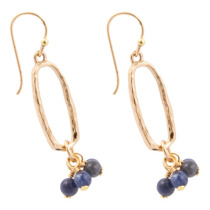 Gold earrings with blue beads on a white background