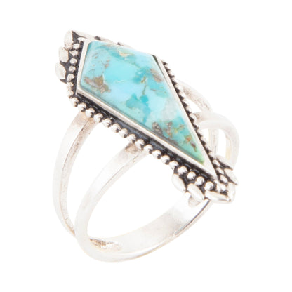 Silver ring with turquoise stone on a white background