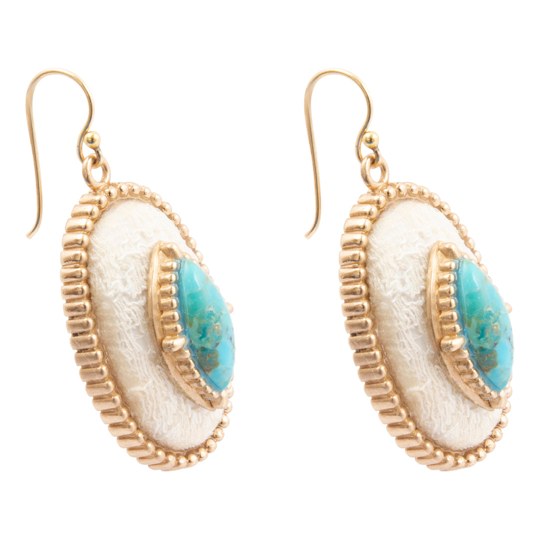 Pair of earrings with gold frame, white center, and blue accents on a white background