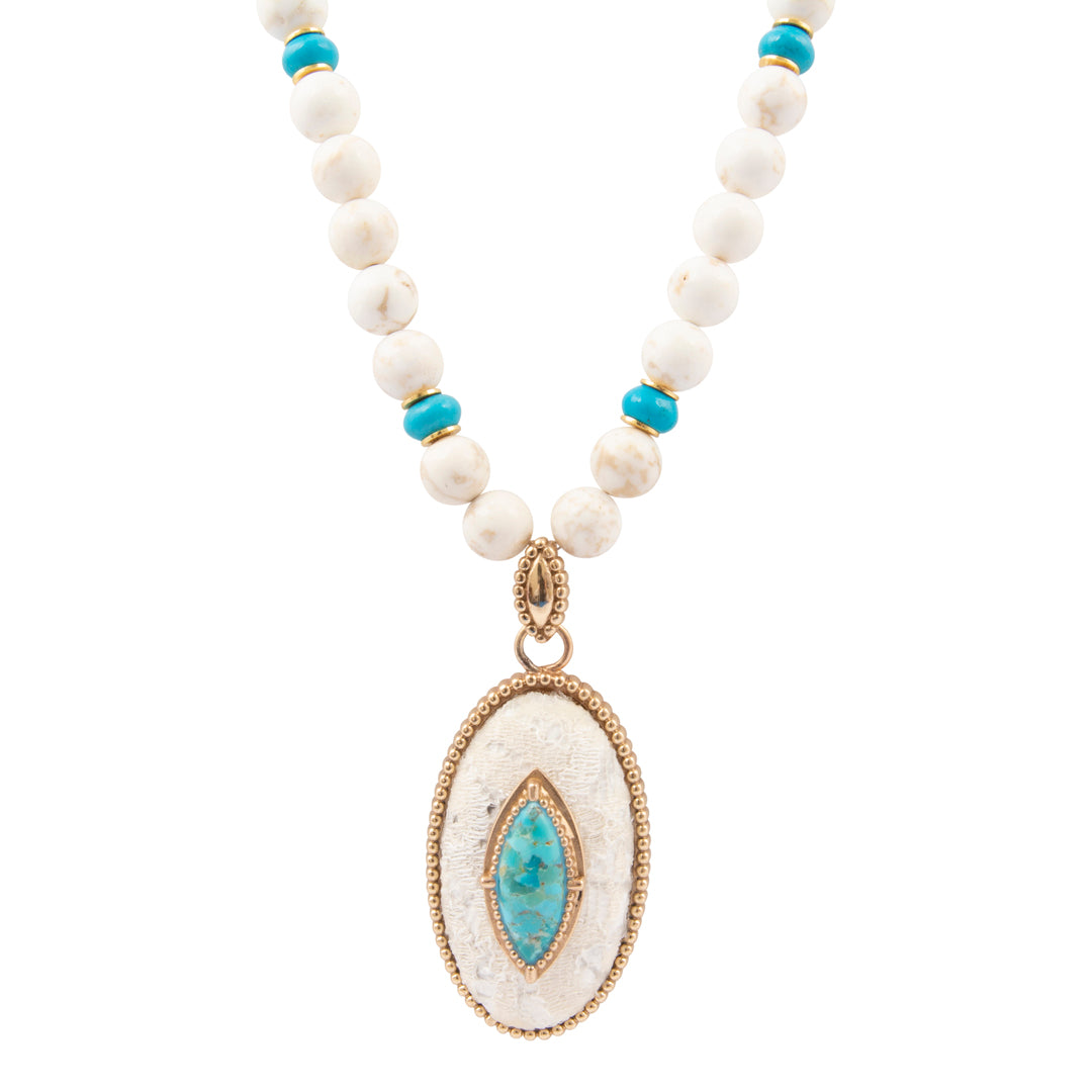 Necklace with white beads, blue stones, and a gold pendant on a white background