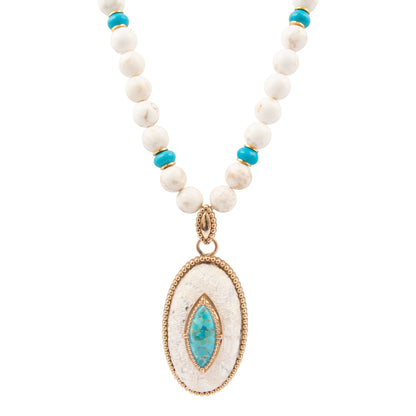 Necklace with white beads, blue stones, and a gold pendant on a white background