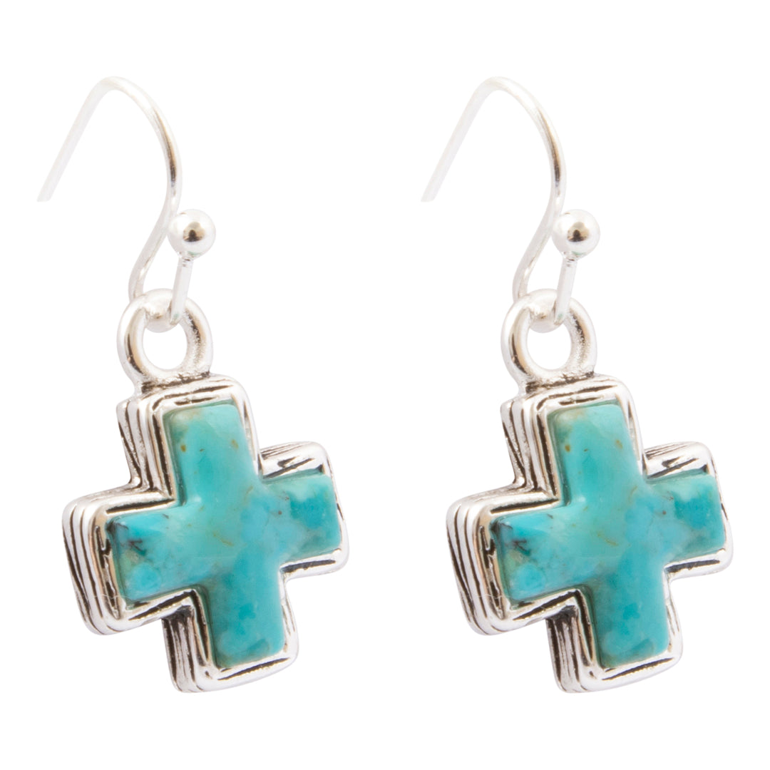 A pair of silver drop earrings featuring turquoise cross pendants, shown against a plain white background.