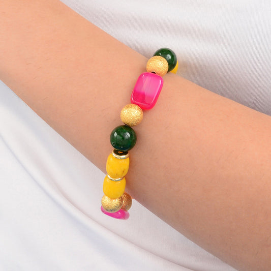 Colorful beaded bracelet on a wrist against a white background