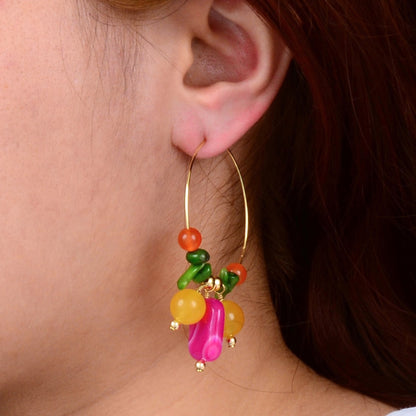 Close-up of a colorful beaded earring worn by a person.