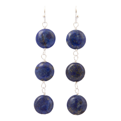 A pair of silver drop earrings featuring three round, polished lapis lazulii beads on each earring, displayed against a solid white background.