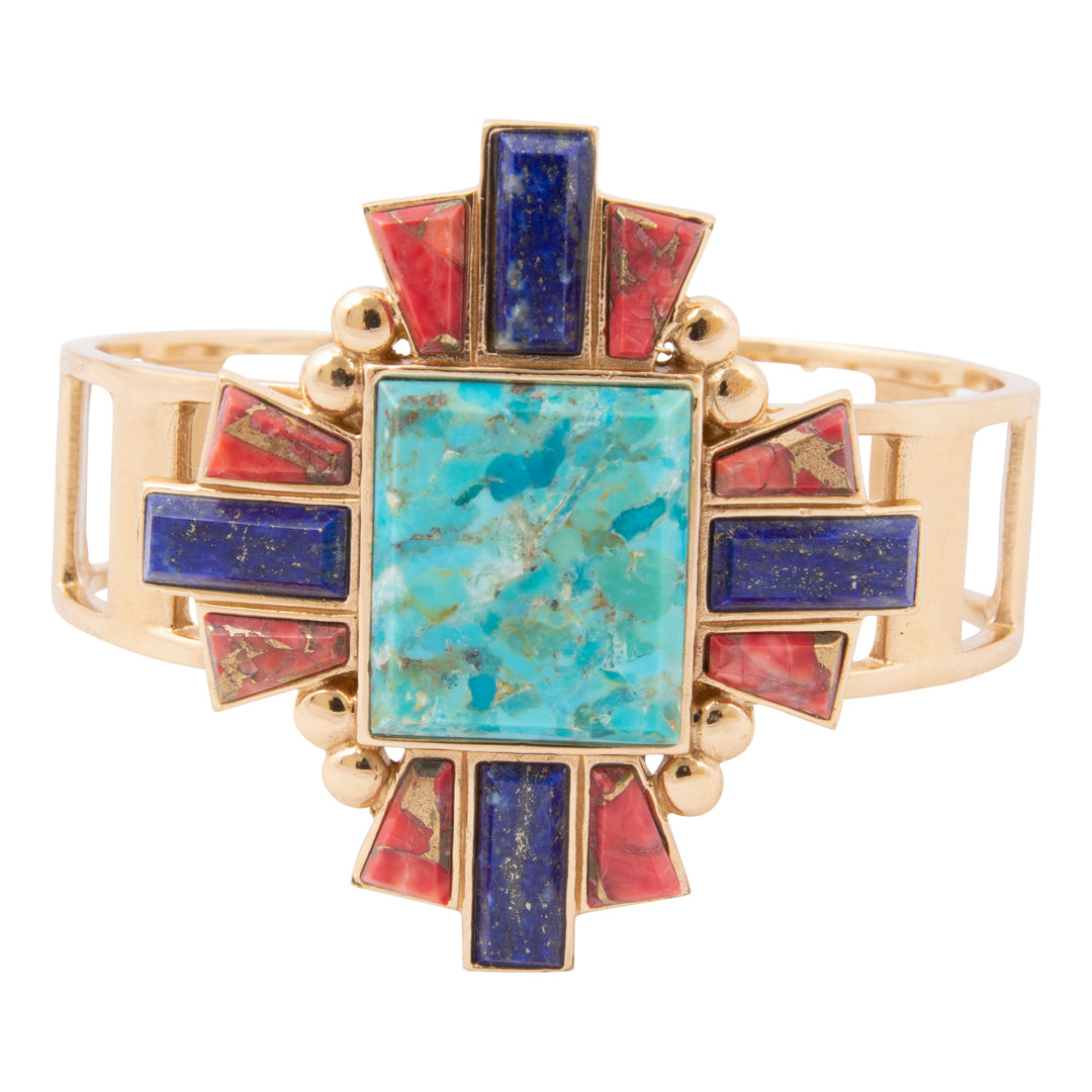 Gold bracelet with turquoise and red stones on a white background