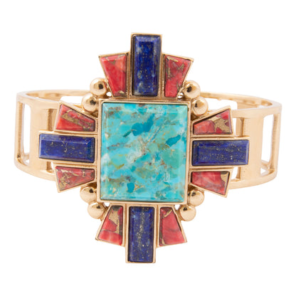 Gold bracelet with turquoise and red stones on a white background