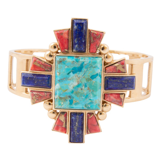 Gold bracelet with turquoise and red stones on a white background