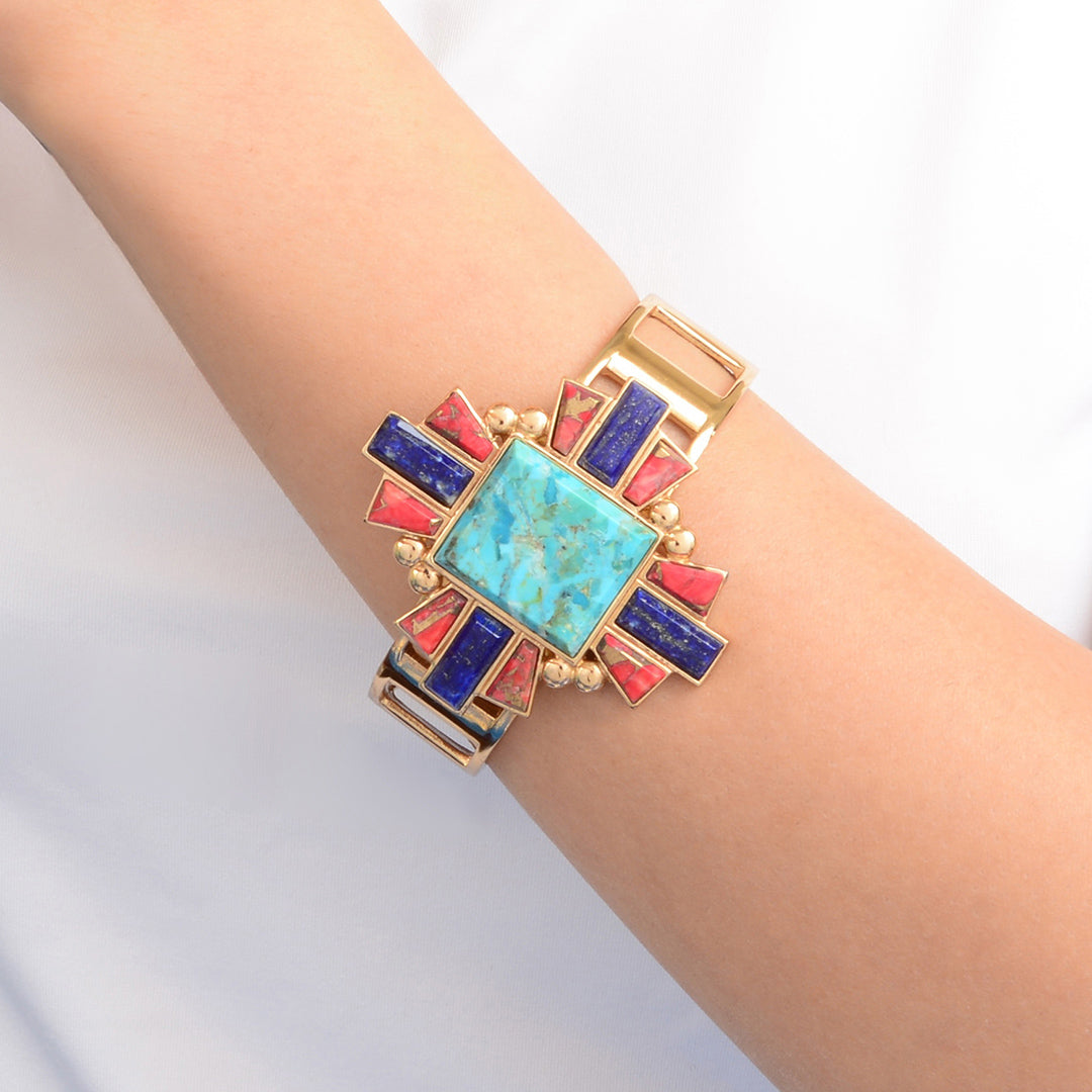 Multicolored geometric bracelet on a wrist against a light background