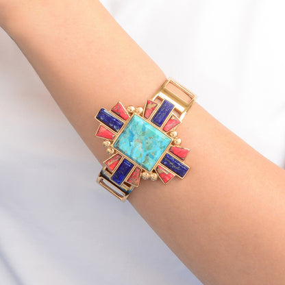 Multicolored geometric bracelet on a wrist against a light background