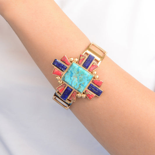 Multicolored geometric bracelet on a wrist against a light background