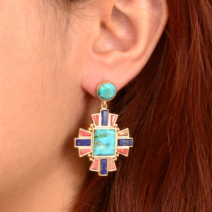 Close-up of a colorful earring worn by a person with red hair.