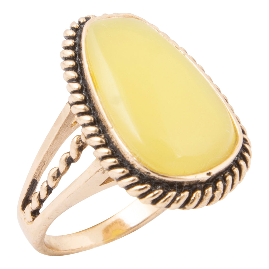 Gold ring with a yellow stone on a white background