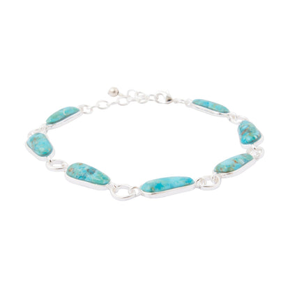 Turquoise bracelet with silver links on a white background