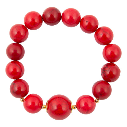 A beaded stretch bracelet made of glossy, polished round red beads with small gold spacer accents, shown on a plain white background.