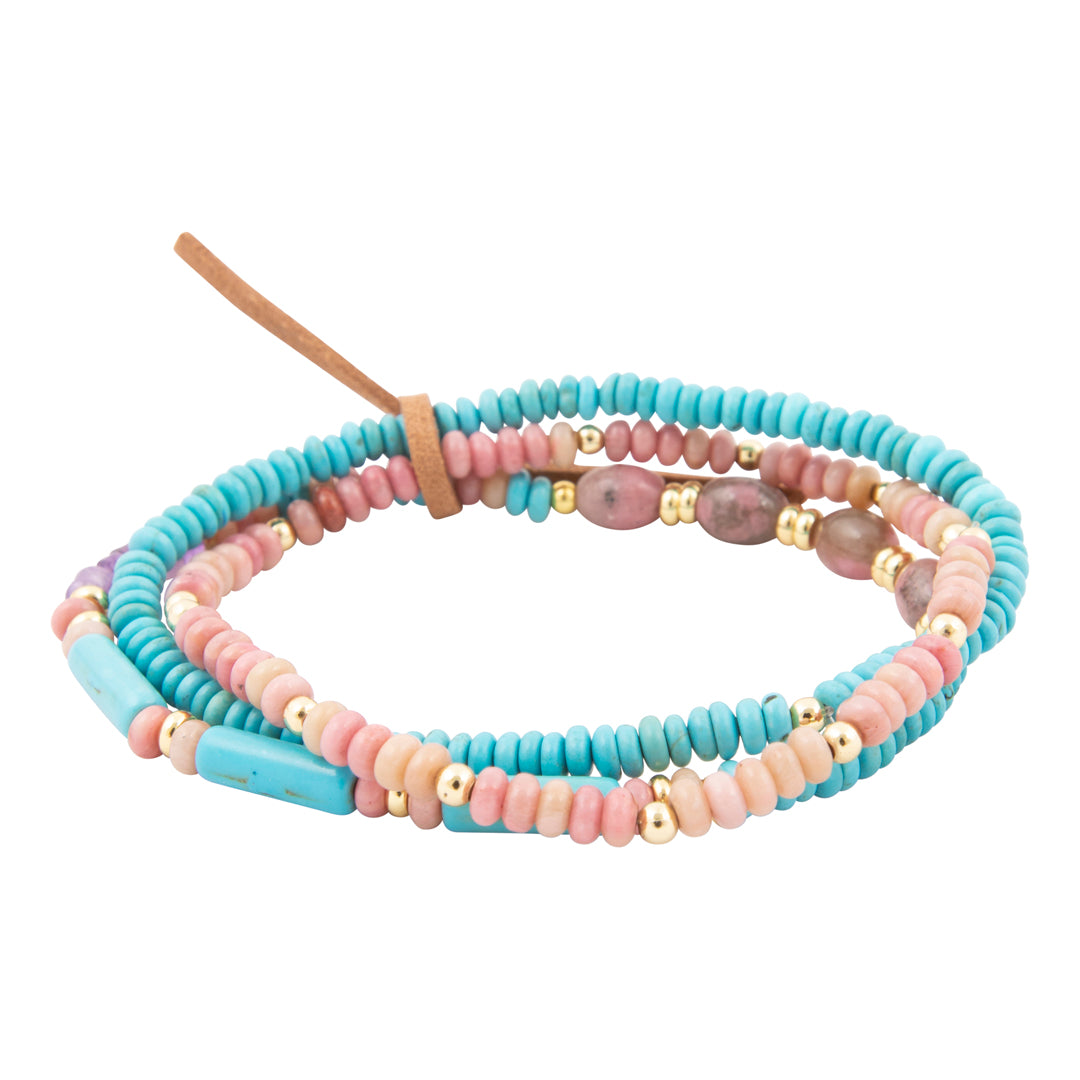 Set of colorful beaded bracelets on a white background