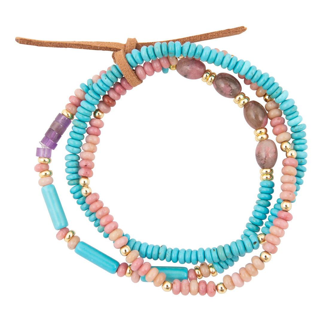 Stack of colorful beaded bracelets on a white background