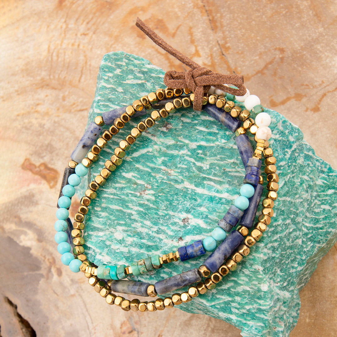 Set of beaded bracelets on a textured stone surface