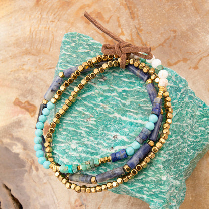 Set of beaded bracelets on a textured stone surface