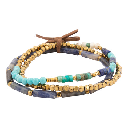 Multistrand beaded bracelet with blue, gold, and turquoise beads on a white background