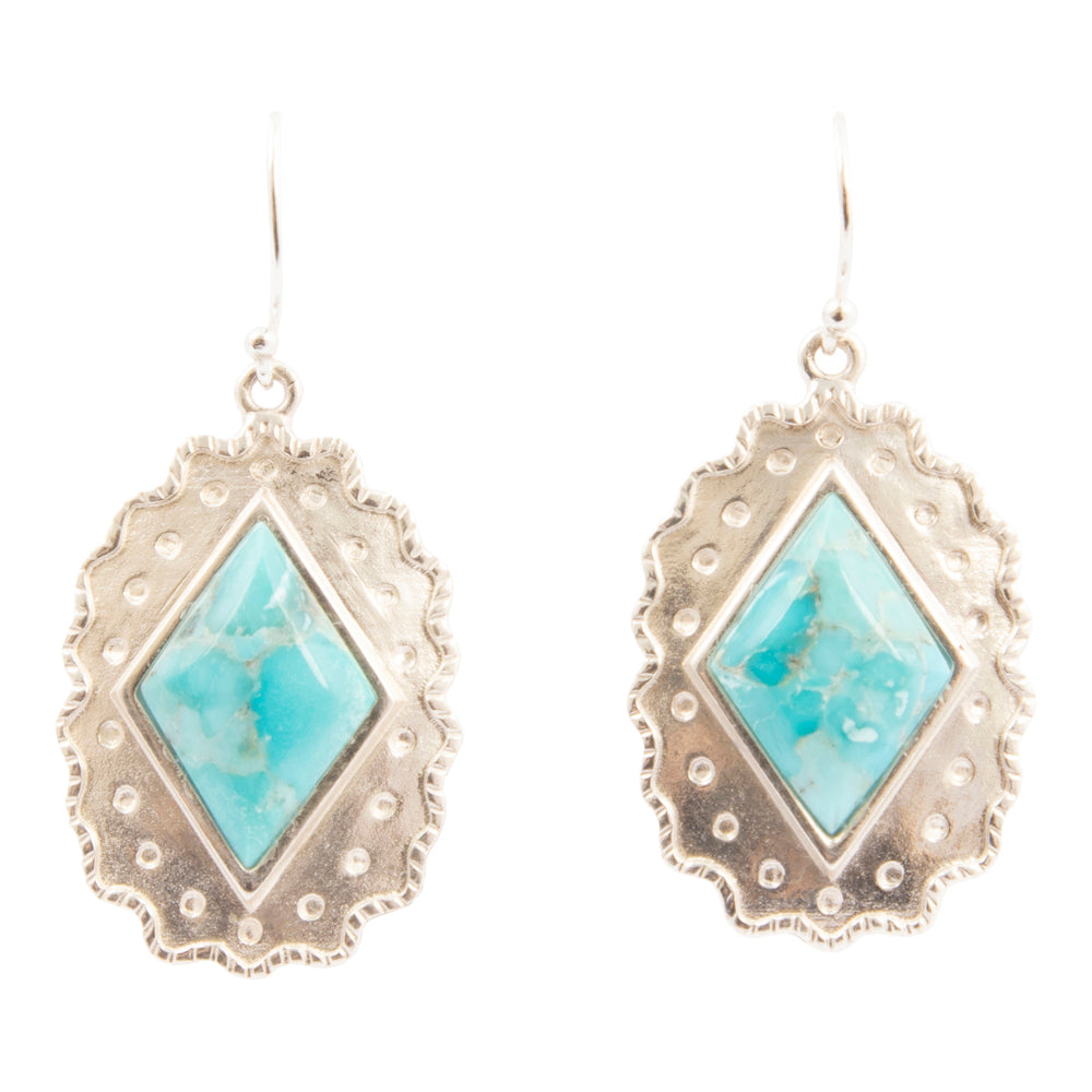 Pair of earrings with turquoise stones and silver frames on a white background