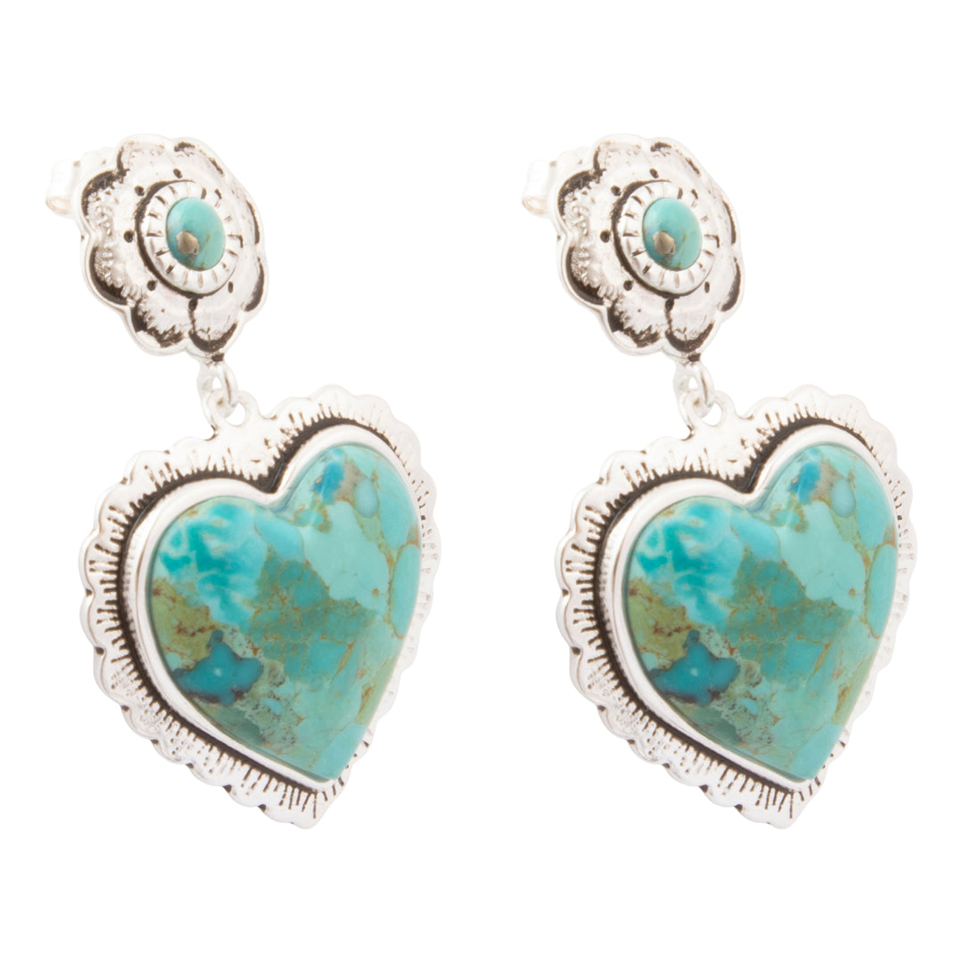 A pair of silver-toned drop earrings featuring heart-shaped turquoise stones with a smaller round turquoise accent above, set against a plain white background.